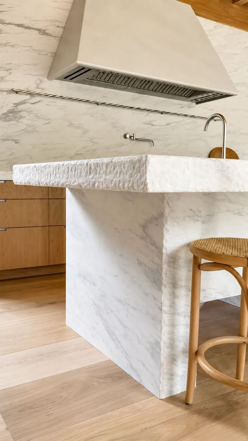 White Imperial Danby waterfall island with split-face edge and marble hood