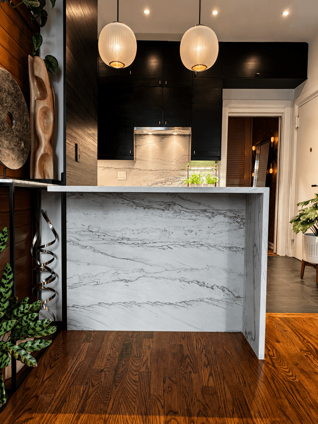 Honed Florida Wave Quartzite waterfall island with pendant lighting