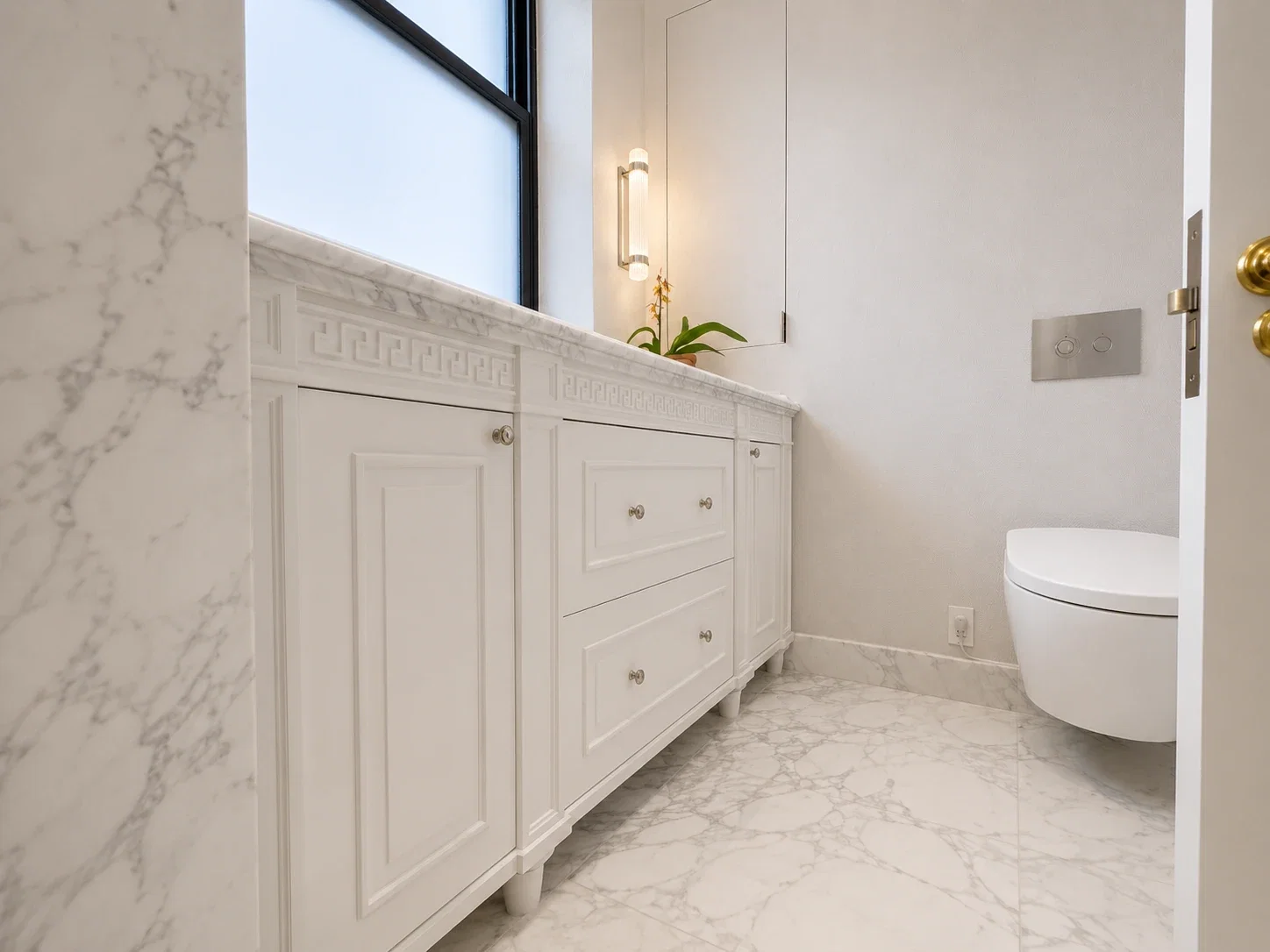Vanity and marble flooring with doorway view to the water closet