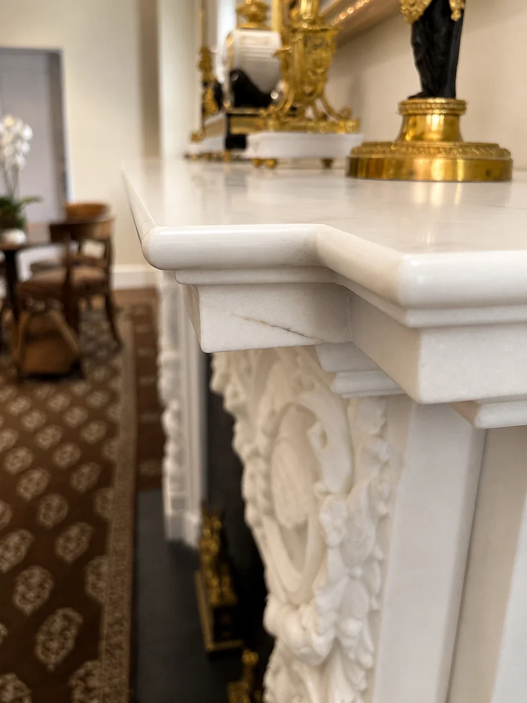 Carved marble mantel shelf edge detail